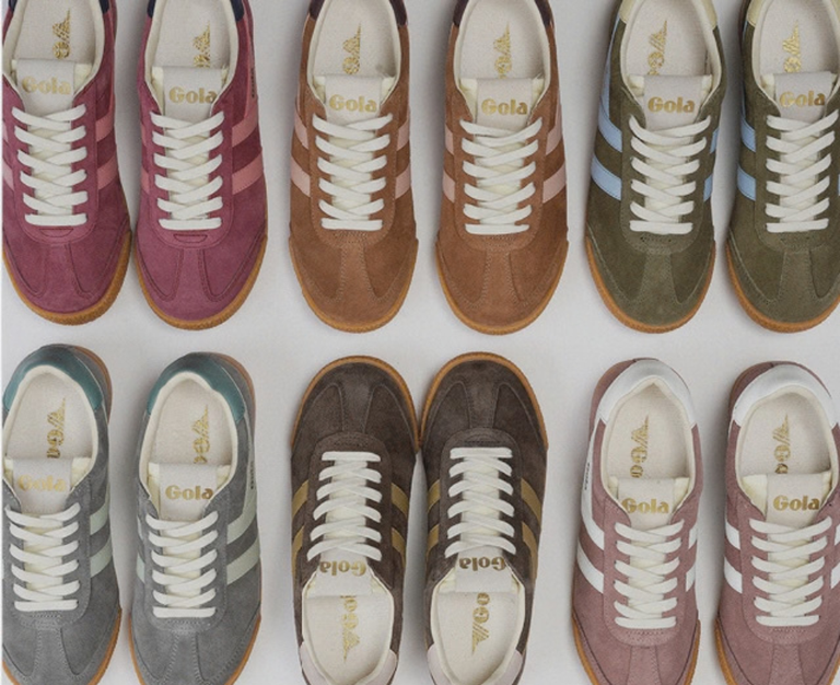 Top view of eight pairs of Gola suede trainers in various colours with white laces and gum soles