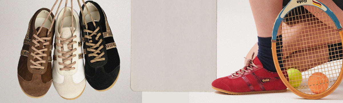 Three Gola trainers hanging by laces next to a red trainer worn with a tennis racket and balls