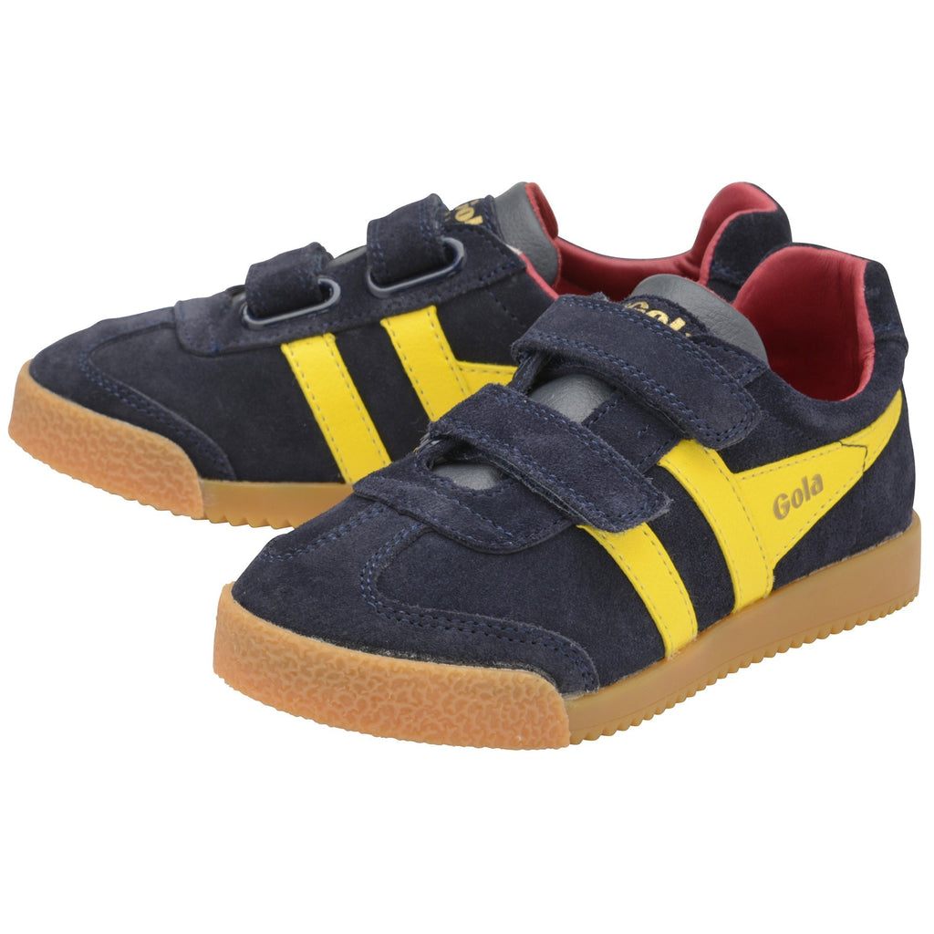 Two navy blue Gola trainers with yellow stripes and velcro straps, viewed from an angle.