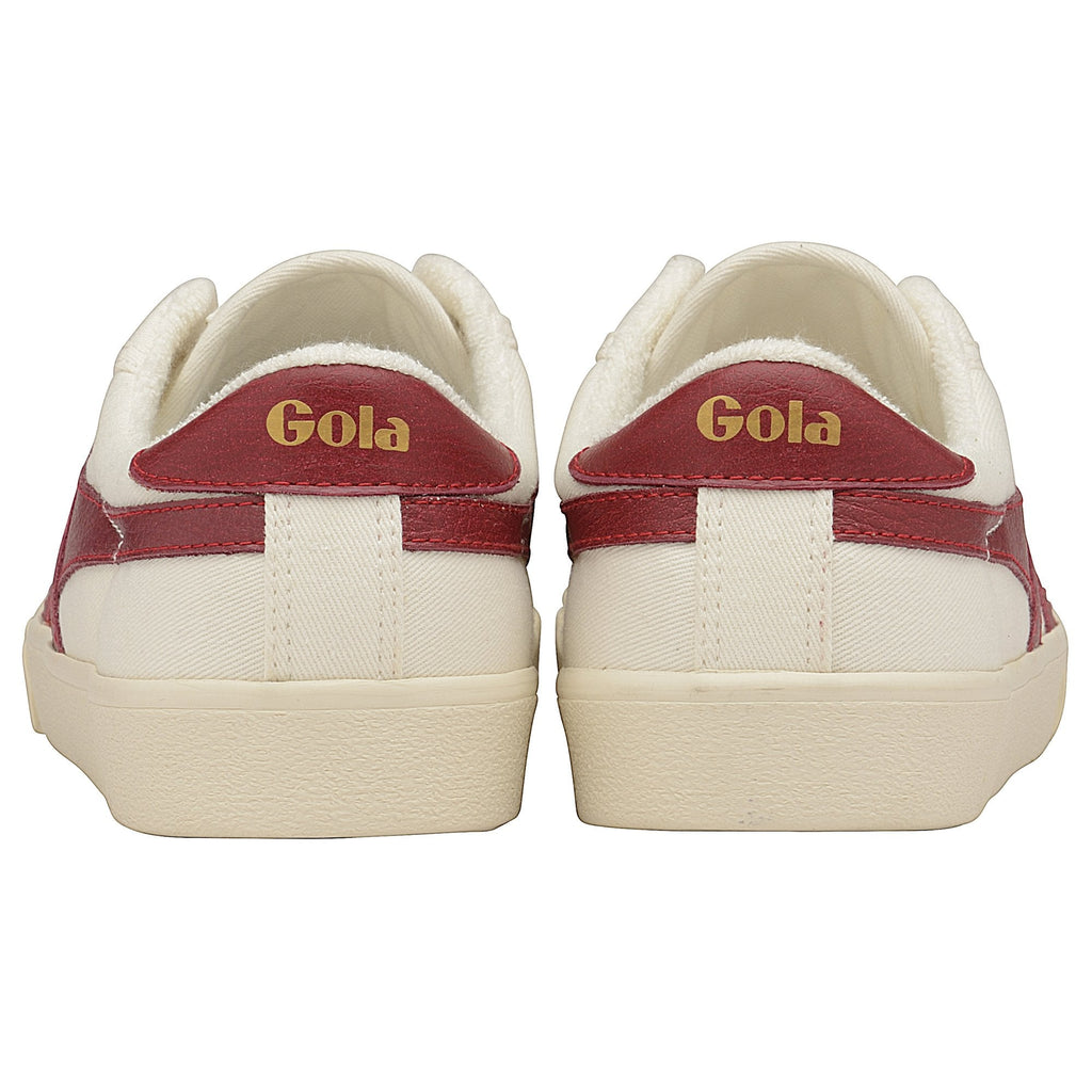 Rear view of a pair of Gola women's low-top sneakers in off-white with two red stripes.