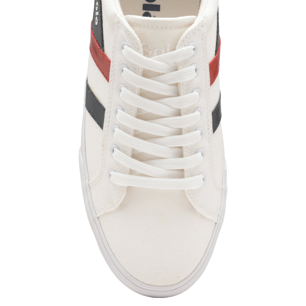 Overhead view of a white Gola sneaker with red and black stripes, and white laces.