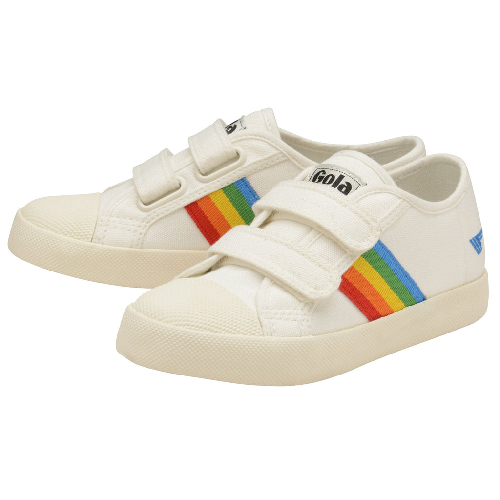 Two white Gola sneakers, each with a rainbow stripe and two velcro straps.