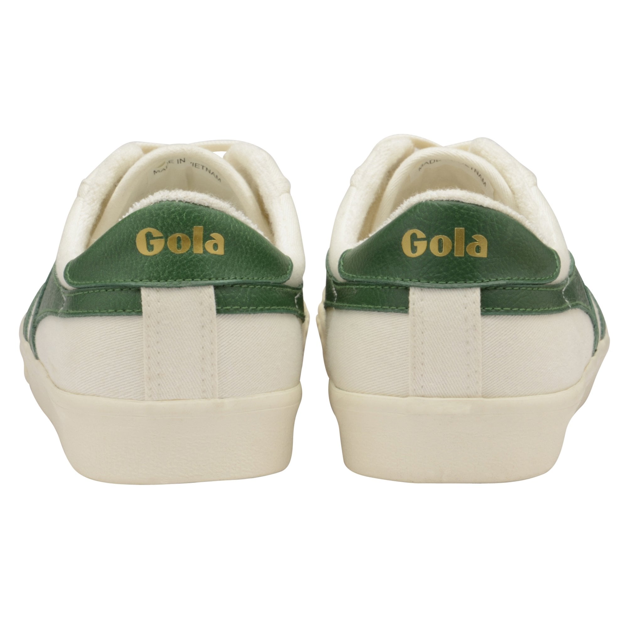 Rear view of two white canvas Gola women's trainers with green accents.