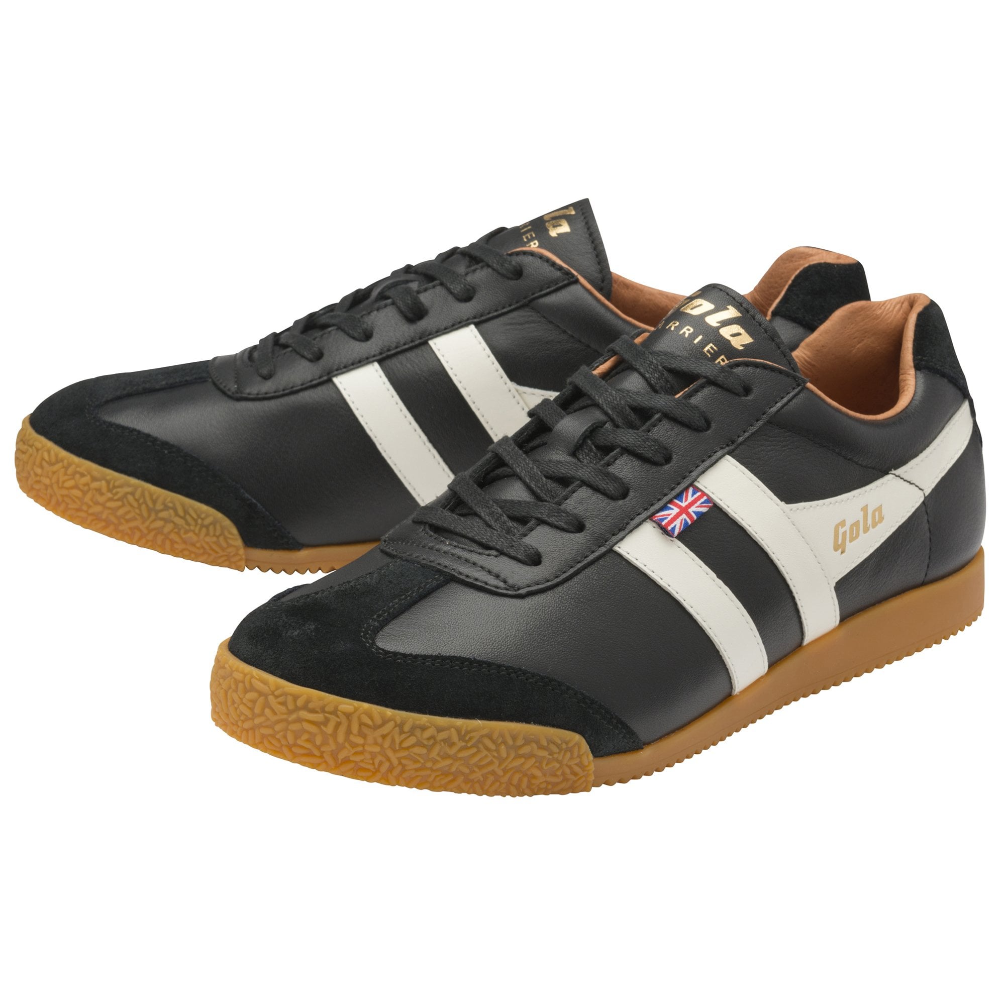 A pair of black Gola Harrier shoes with white stripes and brown soles, angled.