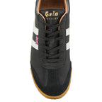The top-down view of a single black Gola Harrier shoe with white stripes and brown sole.