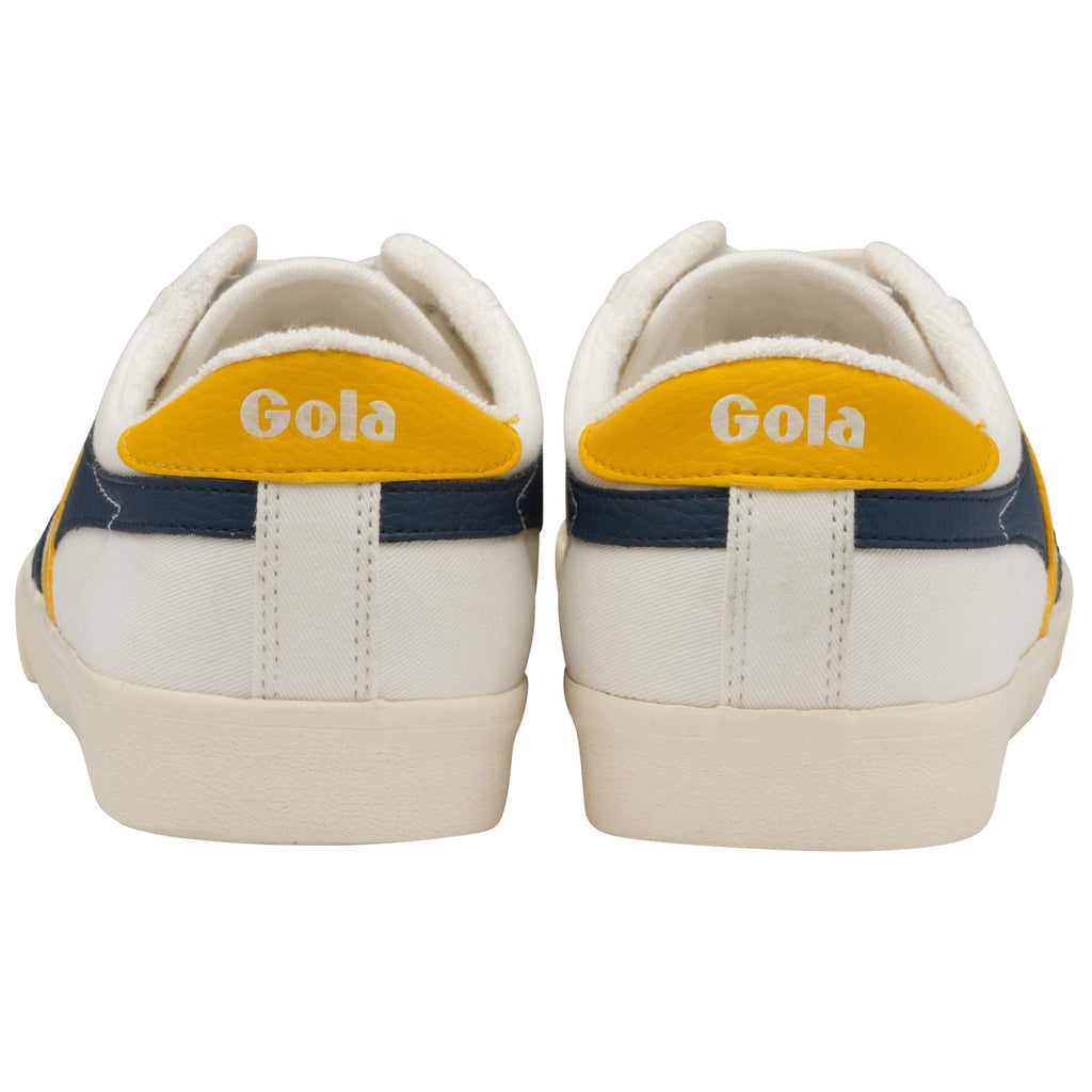 The back of a pair of white Gola sneakers with navy and yellow stripes.