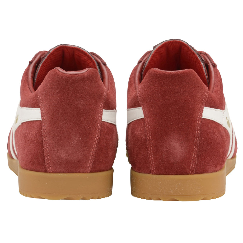 The back view of a pair of red Gola sneakers with white stripes and gum soles.