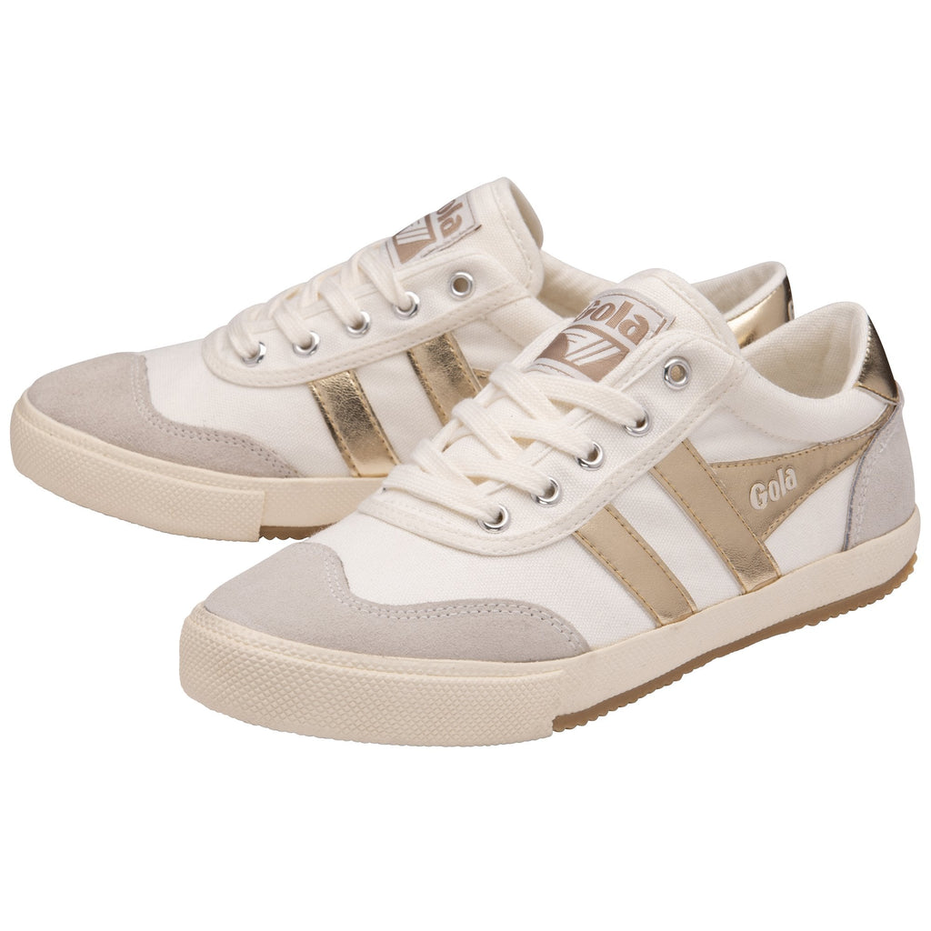 A pair of white Gola sneakers with gold stripes and tan soles, viewed from an angle.