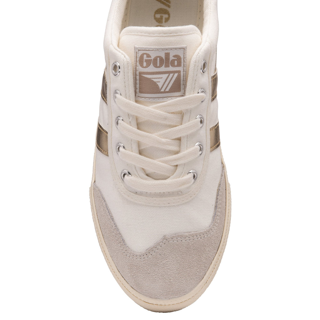 The top-down view of a white Gola sneaker with gold stripes and tan toe cap.