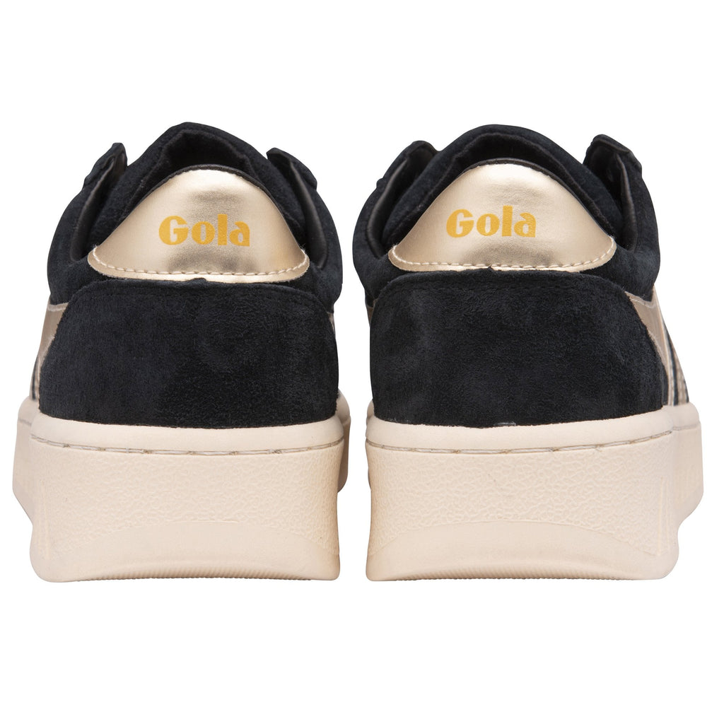 The back view of a pair of black suede Gola Orchid Platform sneakers with gold heels.