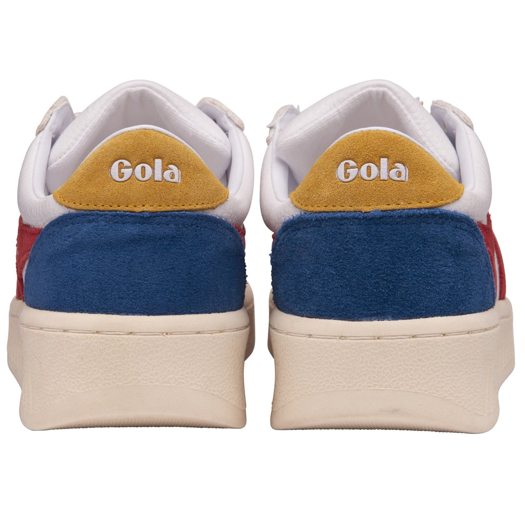 The back of a pair of white trainers with blue and yellow accents on the heel.
