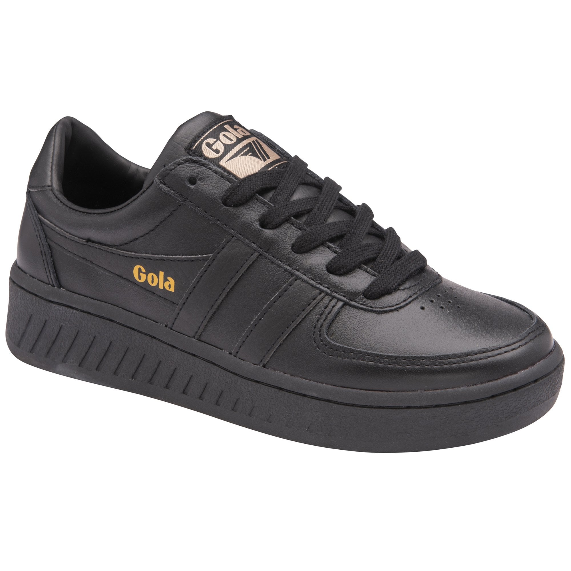 A black Gola trainer with a gold logo on the side and tongue, angled view.