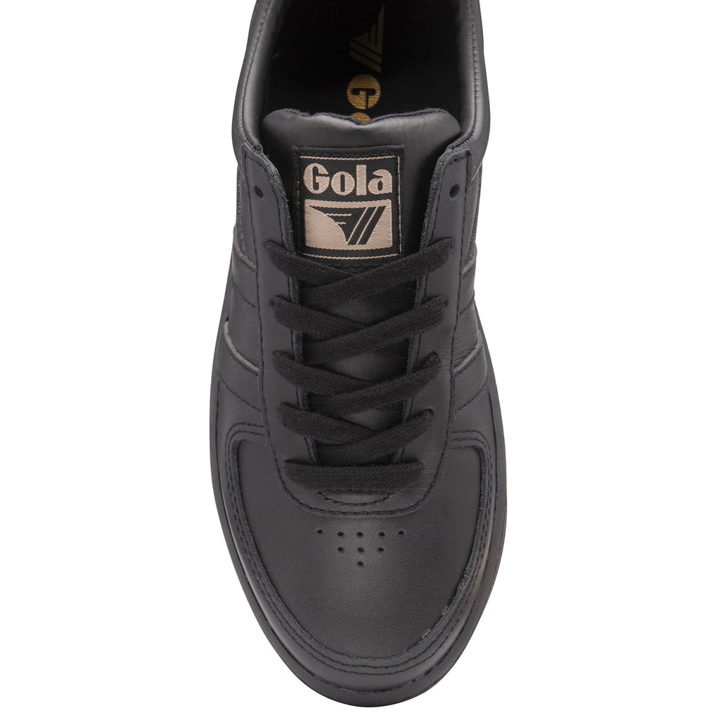 Top-down view of a black Gola trainer with black laces and a gold logo on the tongue.