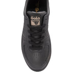 Top-down view of a black Gola trainer with black laces and a gold logo on the tongue.