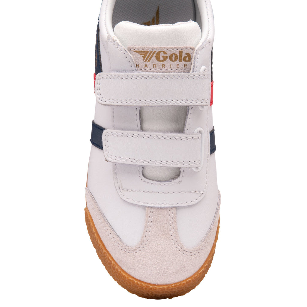 Front view of a white Gola Harrier shoe for children with red and blue stripes and velcro straps.