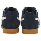 The back view of a pair of navy Gola men's Harrier sneakers with white stripes.