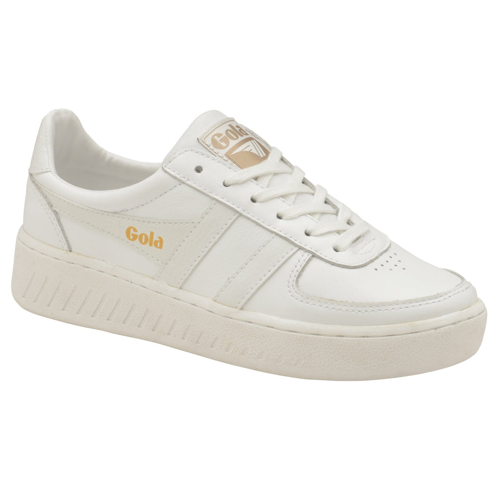 Angled side view of a white Gola sneaker with gold logo on a white background.