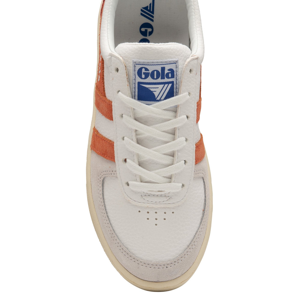 A top-down view of the front of a white Gola sneaker with orange stripes and a blue logo.