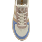 The front of a Gola women's trainer, showing cream, blue, pink, and gold details.