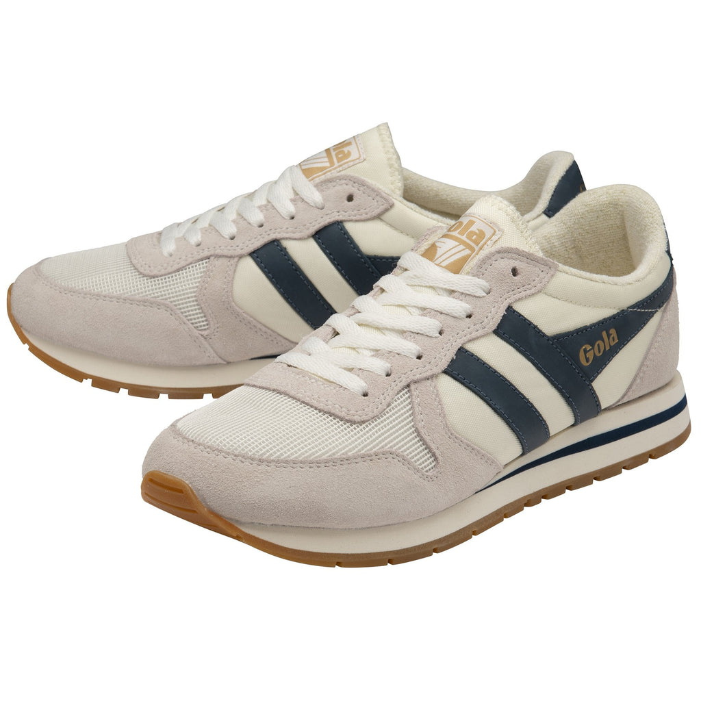 A pair of Gola Daytona trainers in off-white with navy stripes, slightly overlapping.