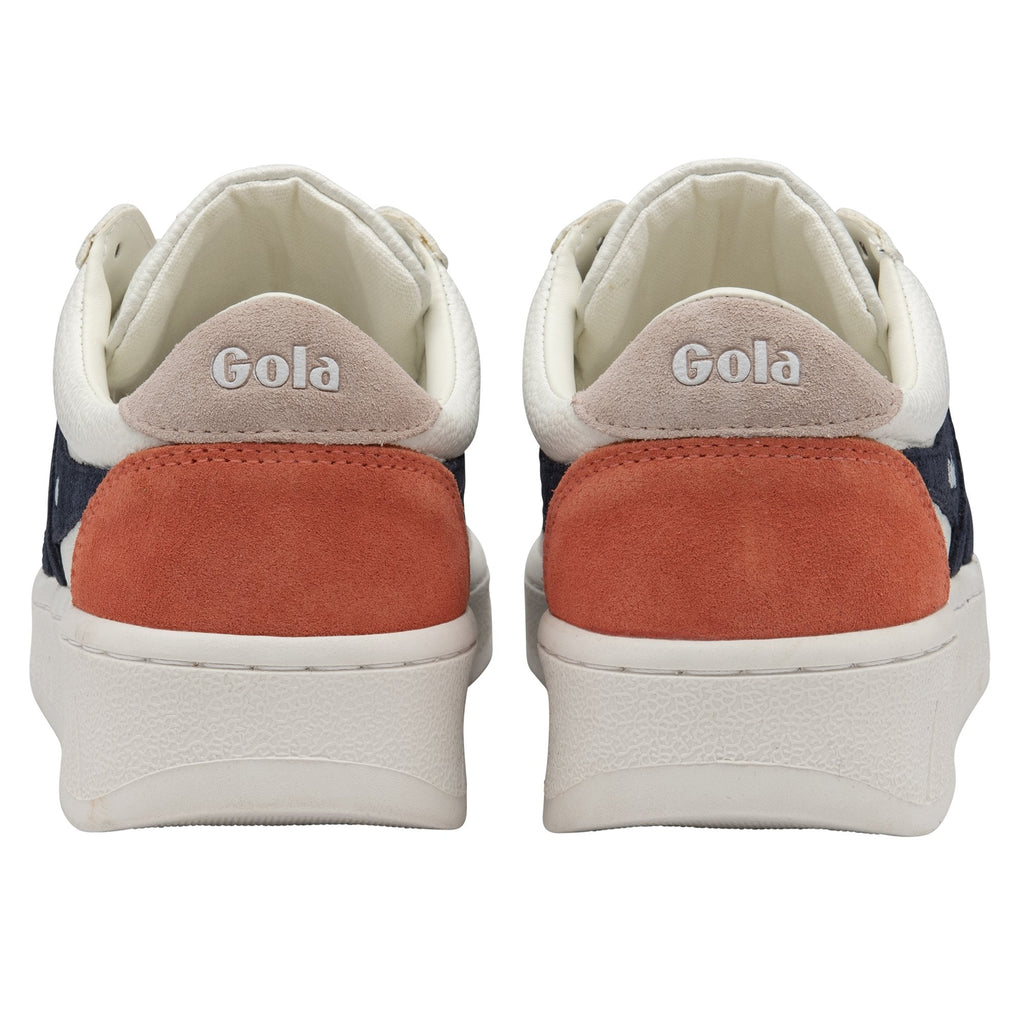 The back view of a pair of white Gola sneakers with orange heel accents and Gola branding.