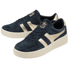 A pair of Gola women's low-top sneakers in navy with gold accents on a white background.