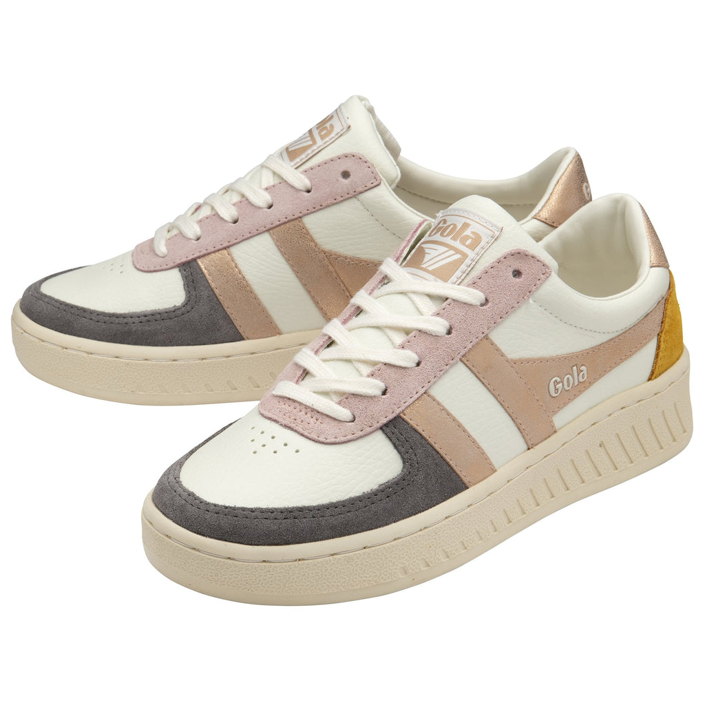 A pair of white Gola sneakers with rose gold, pink, and gray accents and a yellow heel.