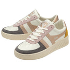 A pair of white Gola sneakers with rose gold, pink, and gray accents and a yellow heel.