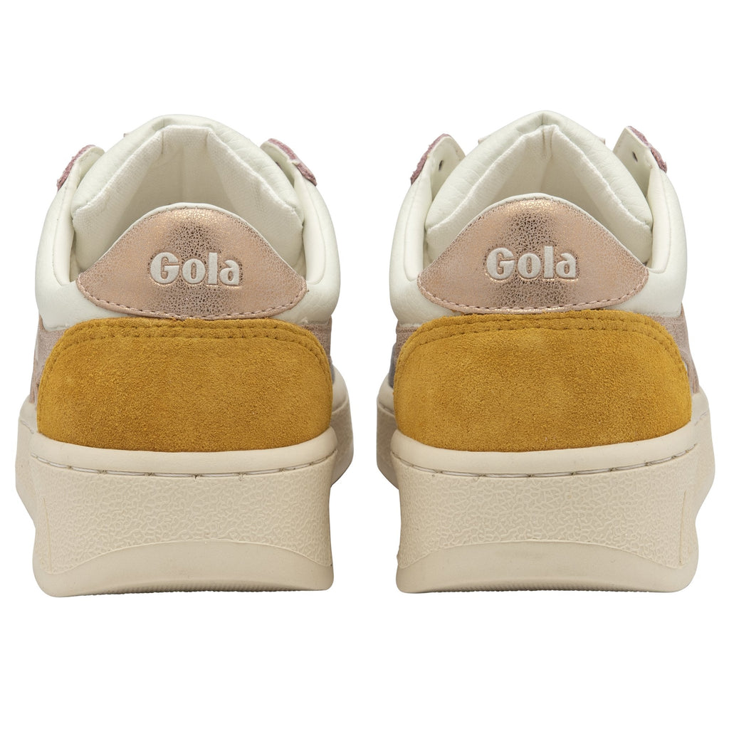The back of a pair of Gola sneakers with yellow heels and rose gold tops.