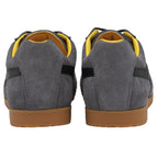 The rear view of two gray suede Gola sneakers with yellow interiors and brown soles.
