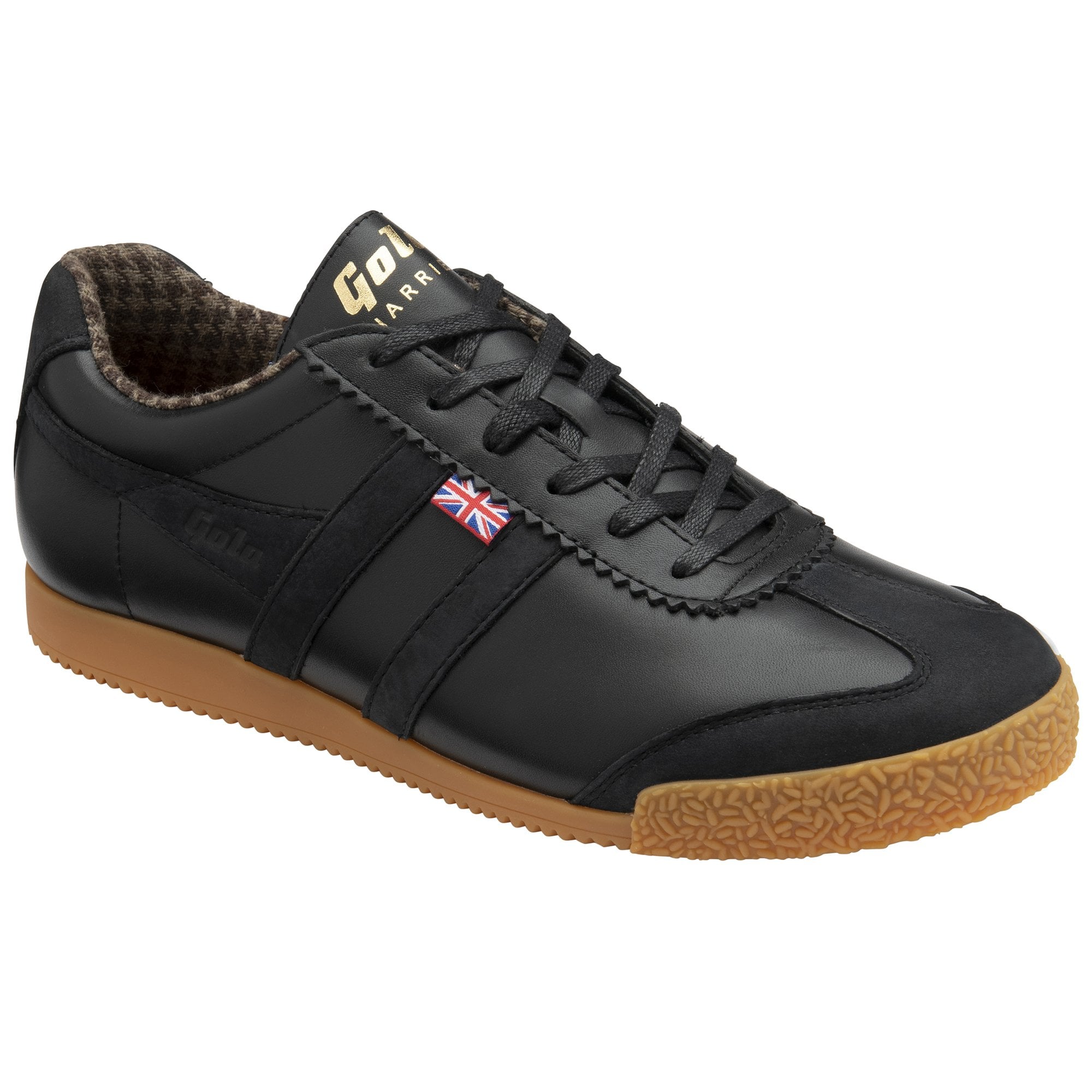 A black sneaker with brown sole, slightly angled view.
