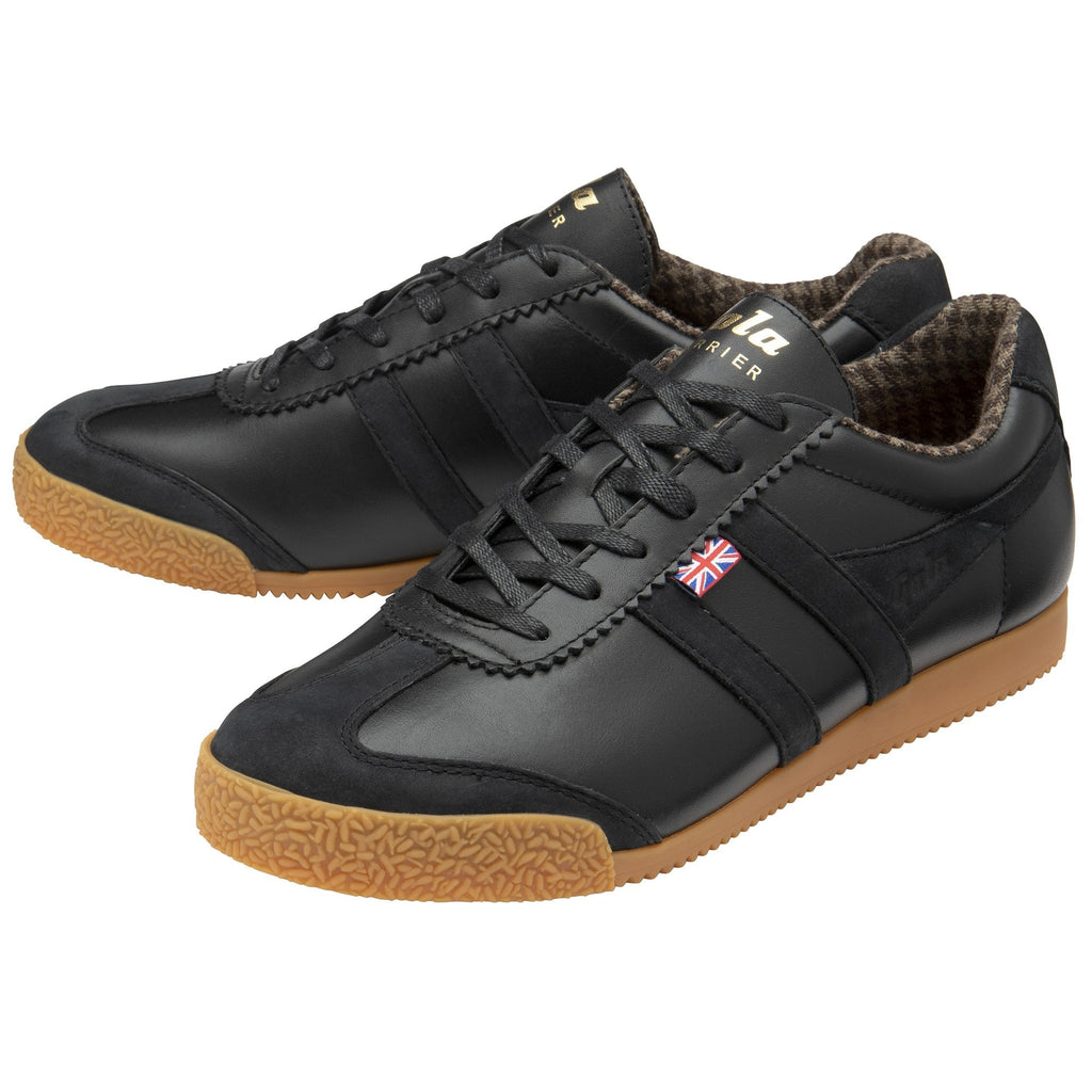 Two black sneakers with brown soles, angled together.