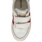 A top-down view of a white Gola sneaker with red stripes and two velcro straps.