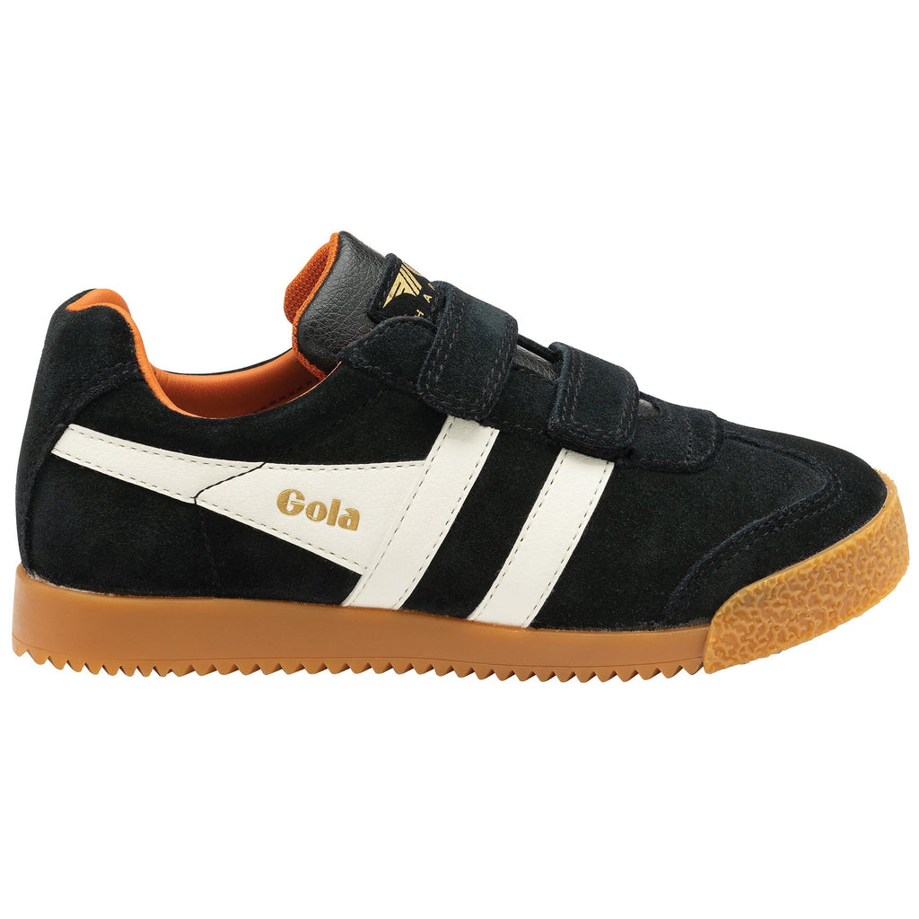 Black and white Gola trainer with Velcro straps and a brown sole, side view.