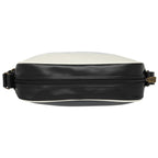 Top view of a black and white messenger bag showing the zipper closure.