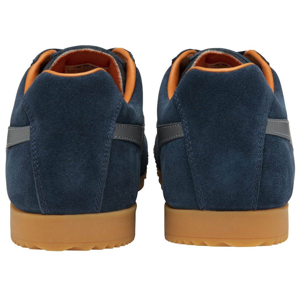 Rear view of a pair of Gola men's Harrier shoes in navy with a gum sole and orange trim.