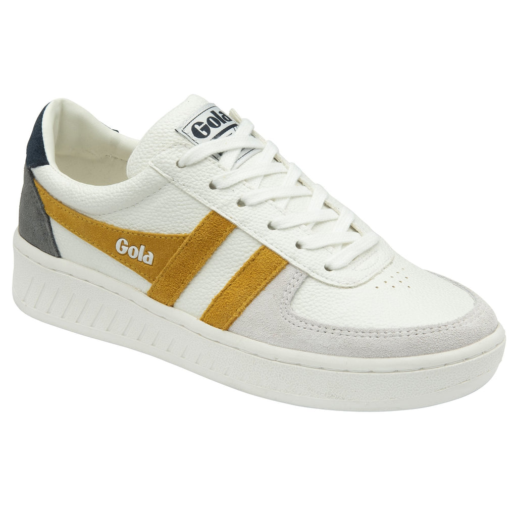 A single white Gola sneaker with gold stripes, from a slight angle.