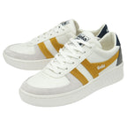 A pair of white Gola sneakers with gold stripes, at an angle.