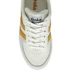 The top-down view of a white Gola sneaker with gold stripes.