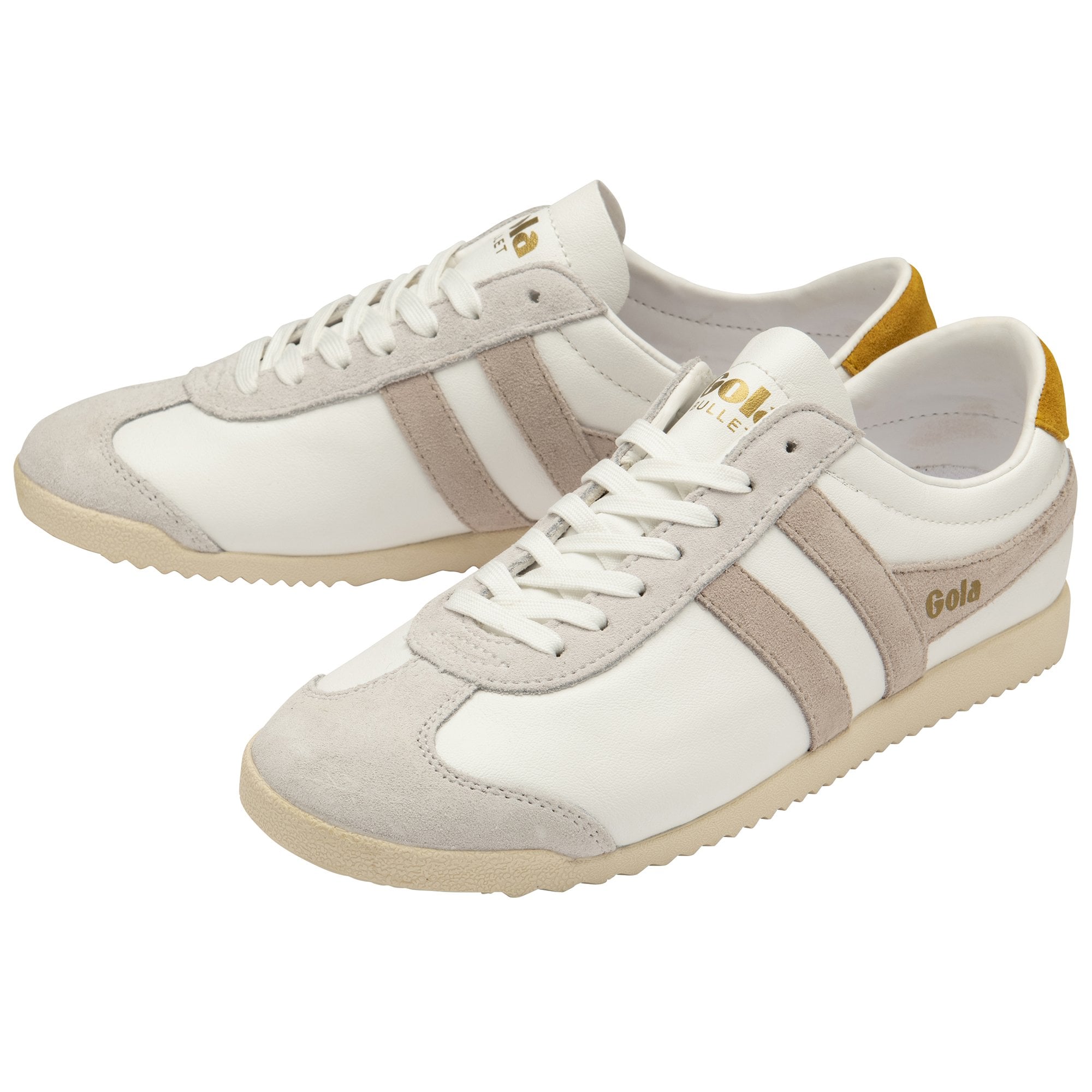 A pair of white and beige Gola Bullet sneakers with gold heel tabs, viewed from an angle.