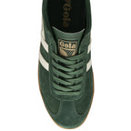 An overhead view of a dark green Gola low-top sneaker with white stripes and a tan sole.