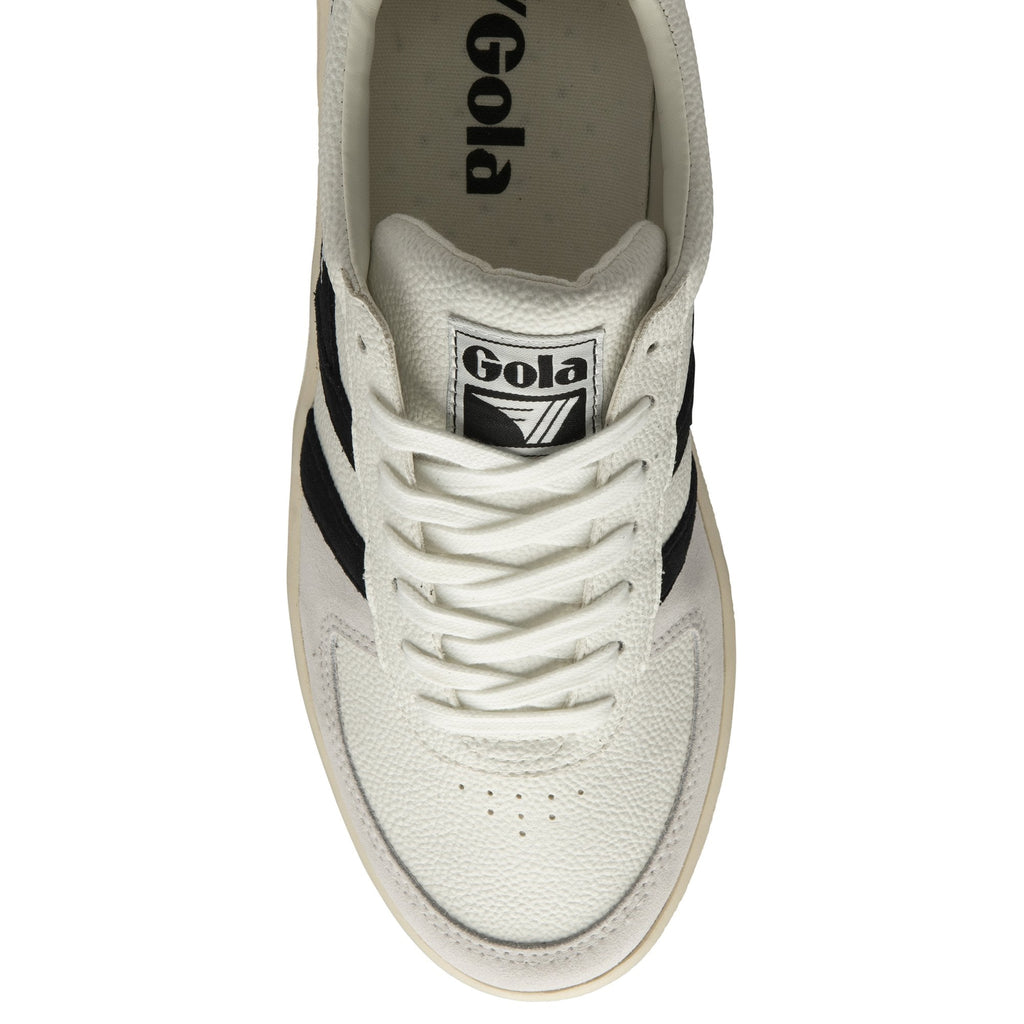 The top-down view of a white Gola sneaker with black stripes and white laces.