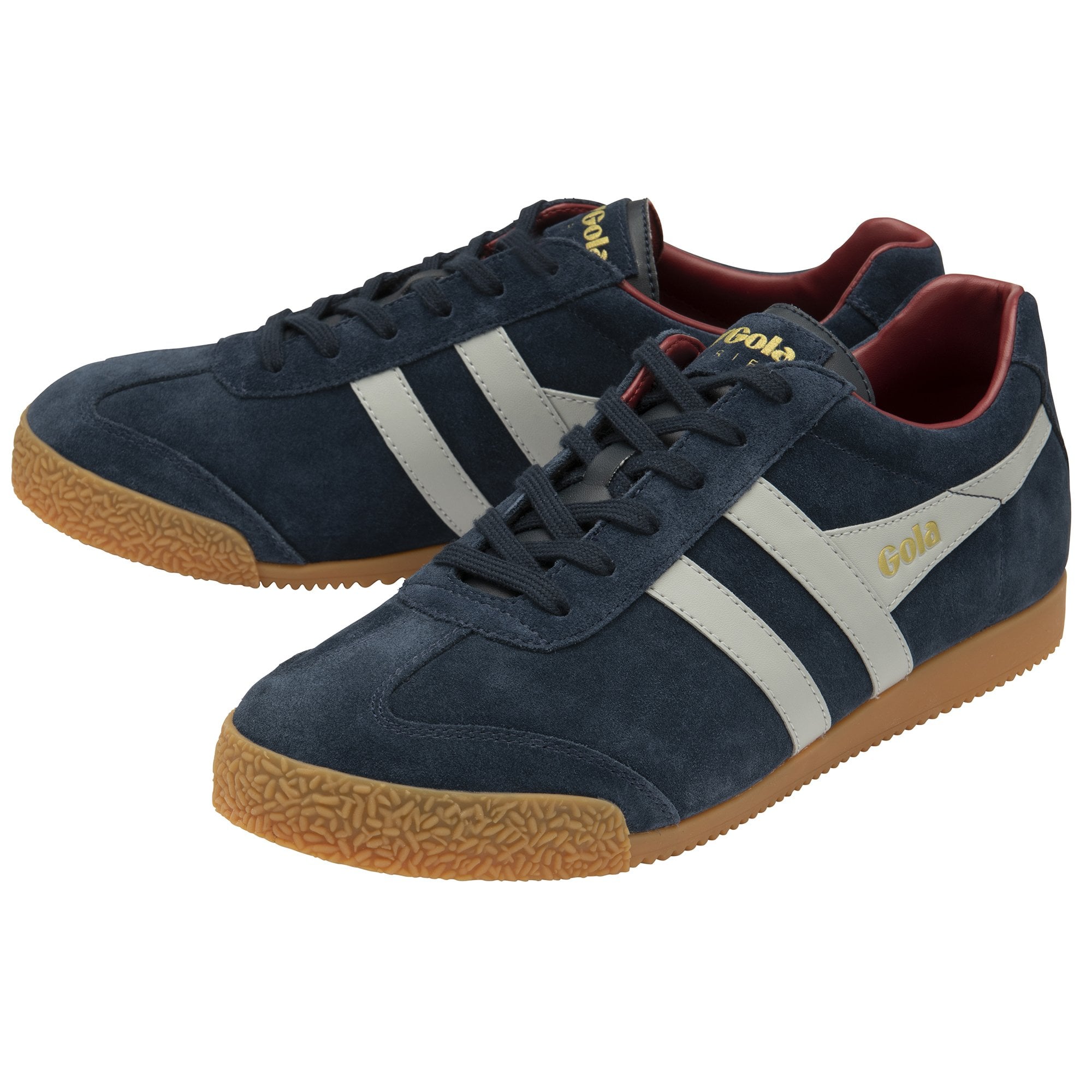 A pair of Gola Harrier trainers in navy blue suede with white stripes and gum soles.