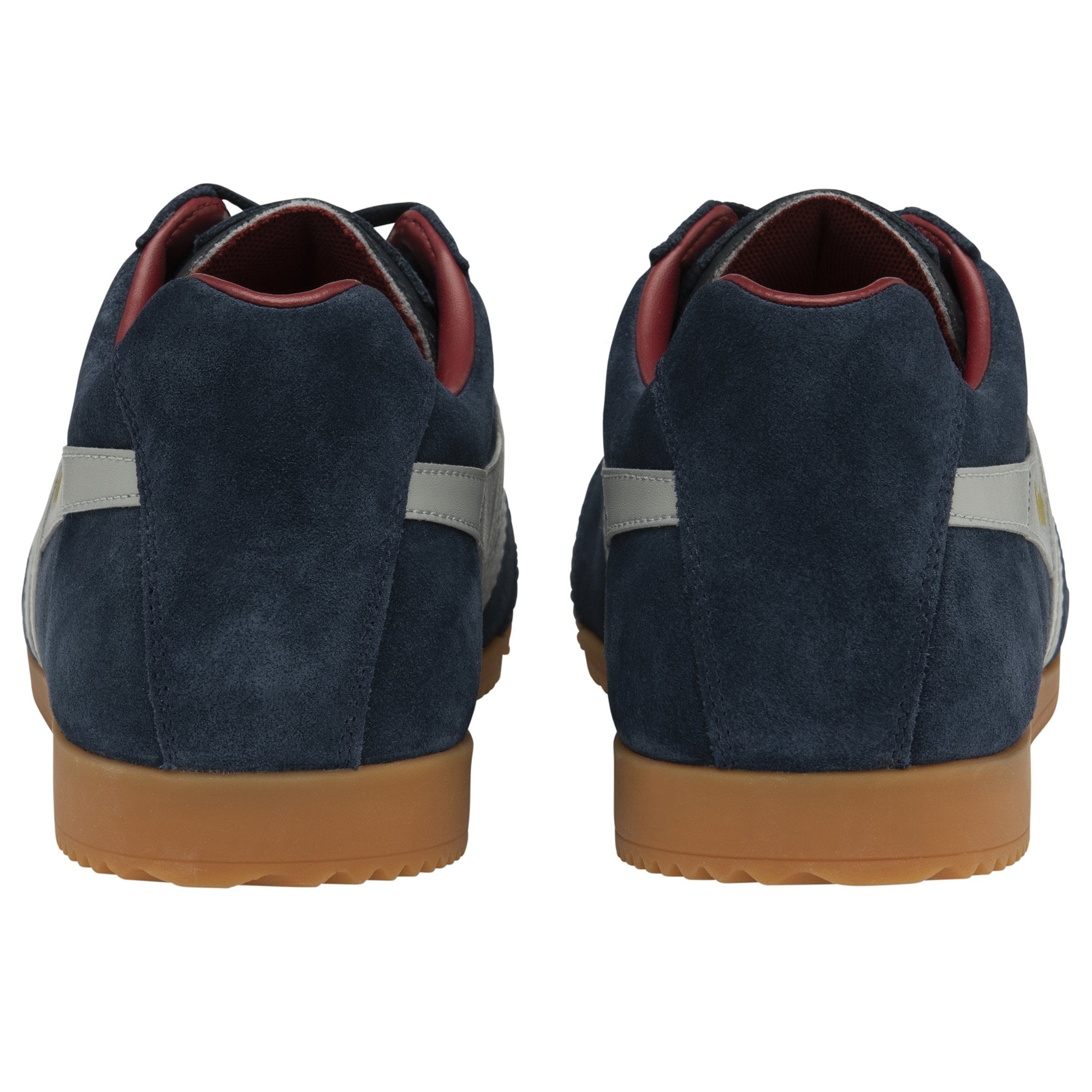 A pair of Gola Harrier trainers, rear view, showing navy blue suede and gum soles.