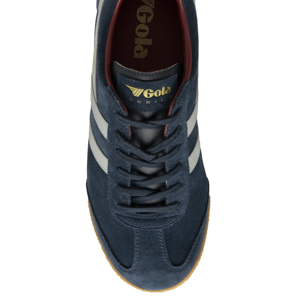 A single Gola Harrier trainer, top-down view, showing navy blue suede and white stripes.