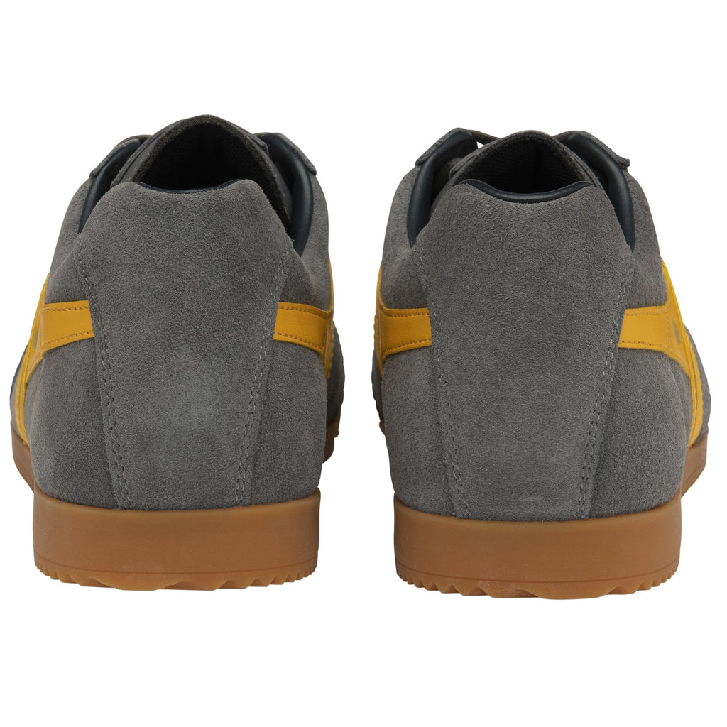 A back view of a pair of grey Gola Harrier shoes with yellow stripes.