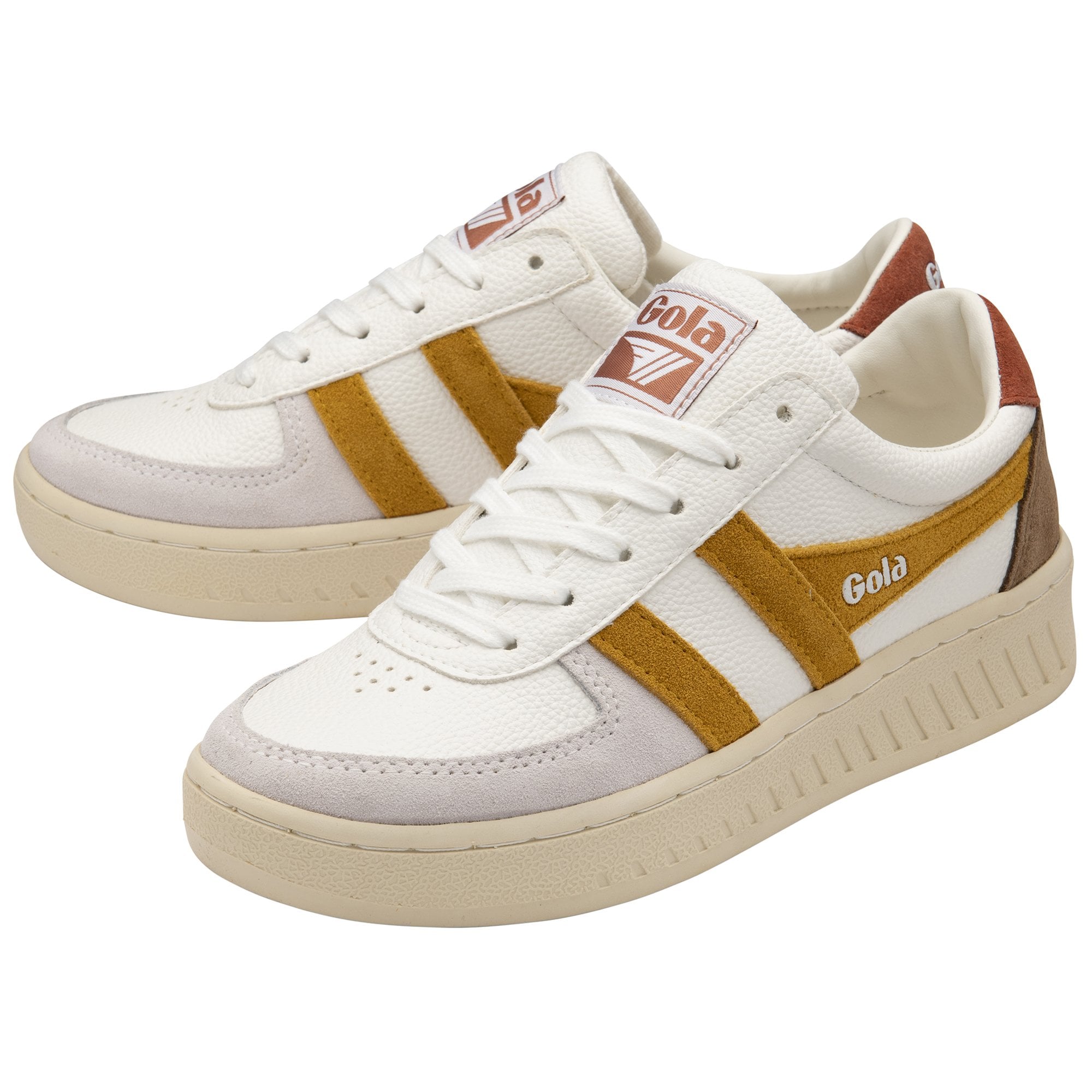 A pair of white Gola sneakers with mustard stripes and brown accents on a white background.