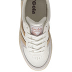 A top-down view of a white Gola sneaker with tan and pink accents.