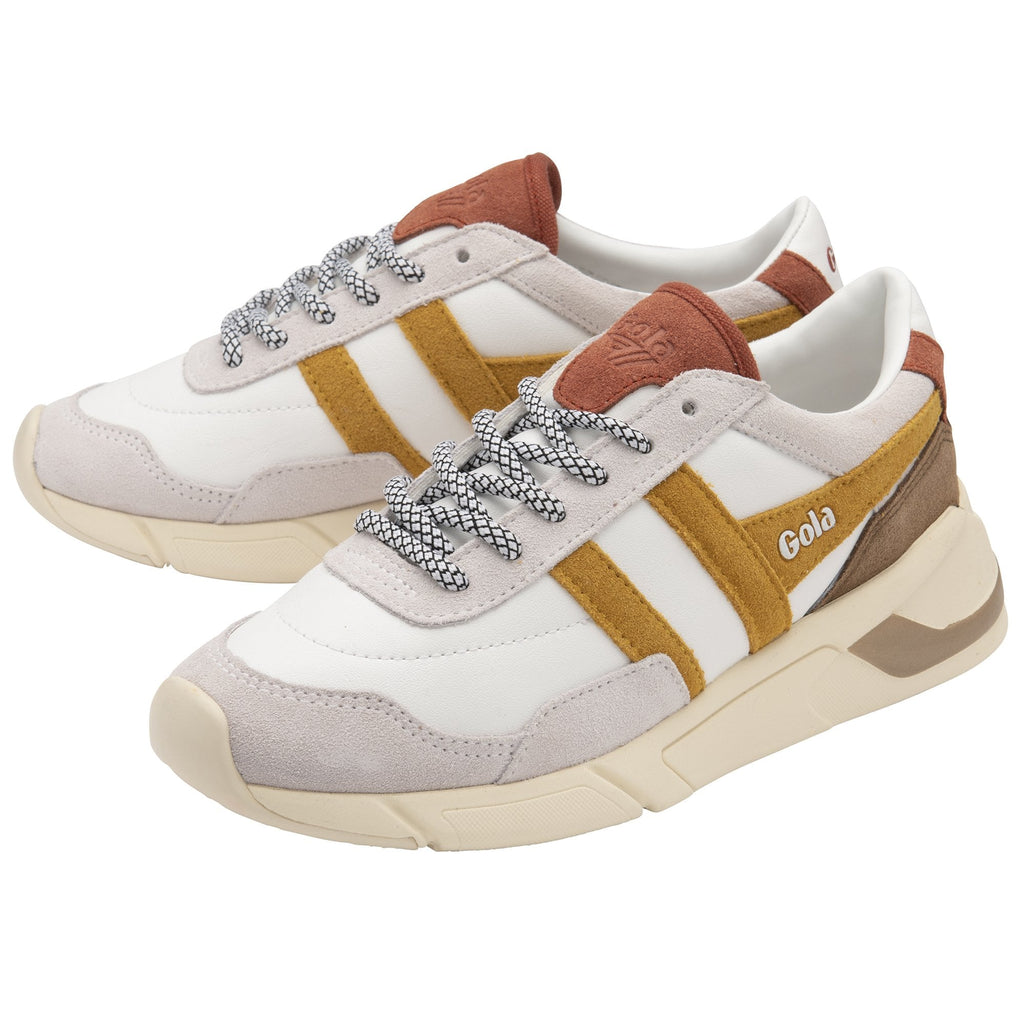 A pair of white Gola sneakers with mustard yellow and brown accents, angled.