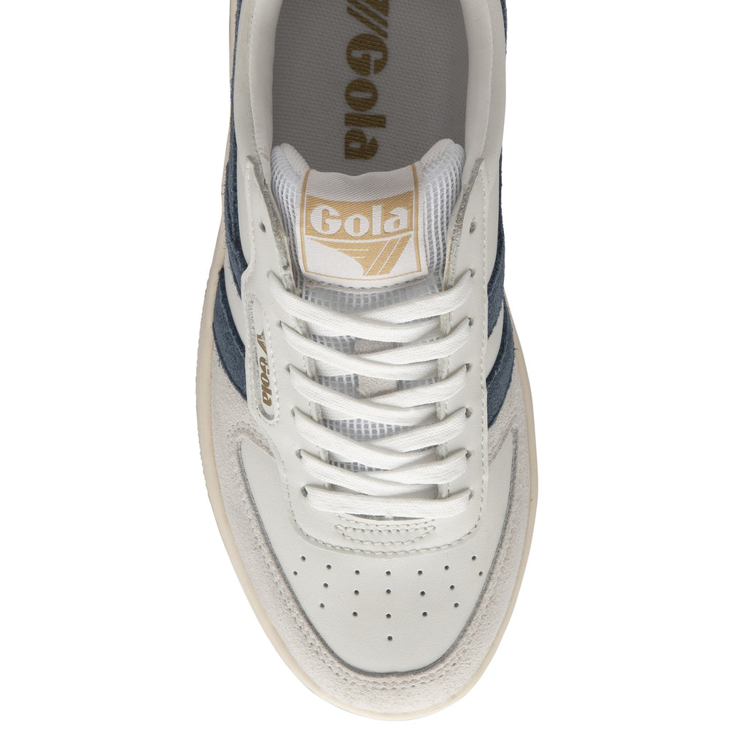 A white and navy Gola sneaker is positioned with the front facing the viewer.